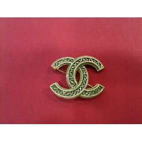 Broche Chanel en métal doré